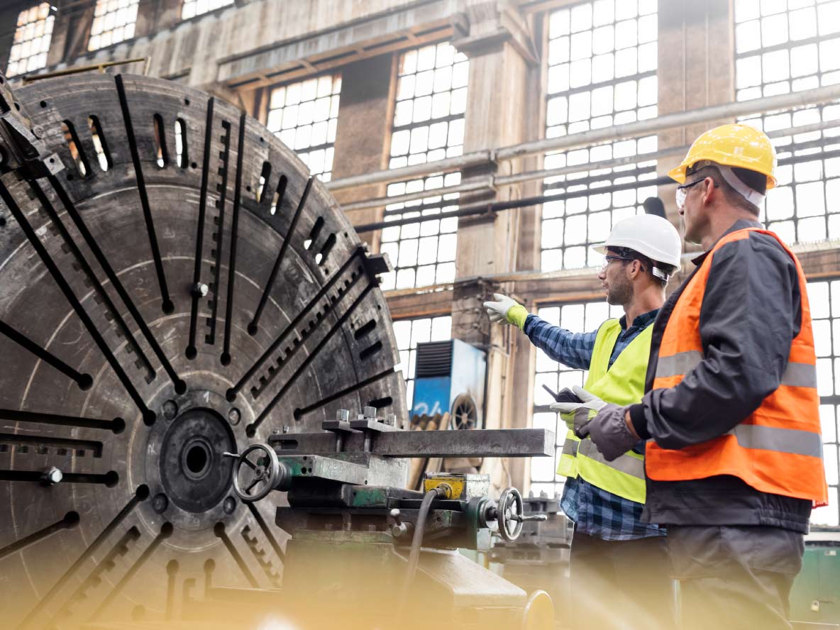 Steel workers talking in factory