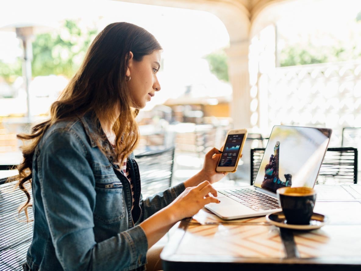 Woman at cafe looking at devices